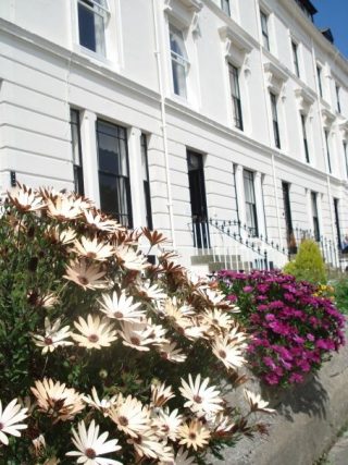 Houses on The Crescent at Filey with flowers in their gardens