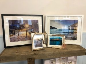 Framed photographs of Filey in shop window