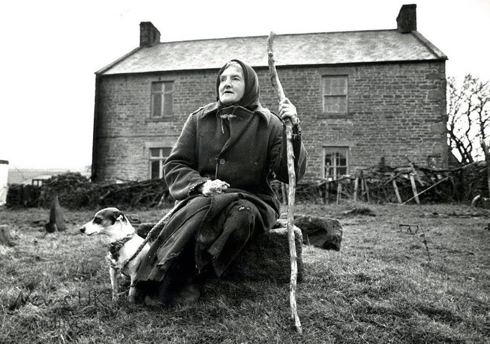 Hannah Hauxwell with dog in front of her Dales farm house