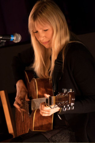 Becky Mills with guitar